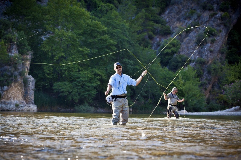 two men false casting fly fishing