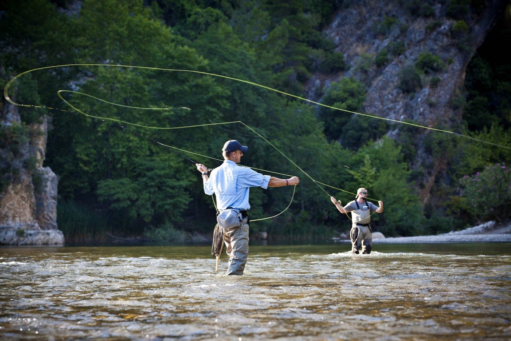 two men fly fishing back casting