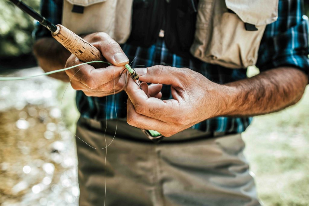 close up tying on flies man fly fishing