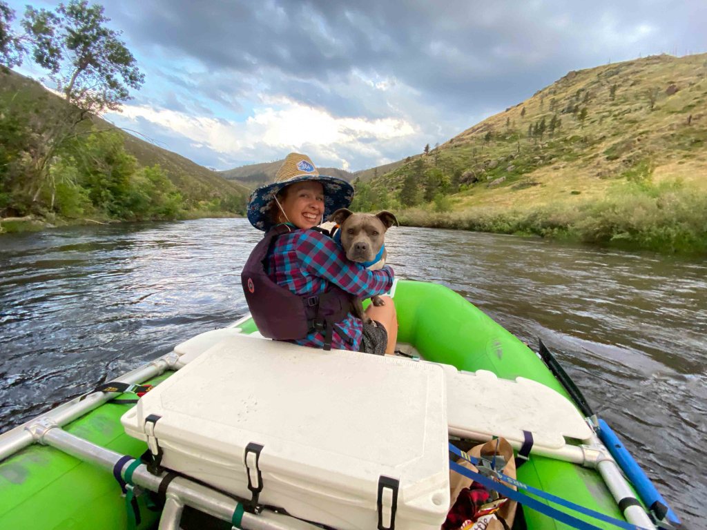 woman and pitbull dog rafting poudre river
