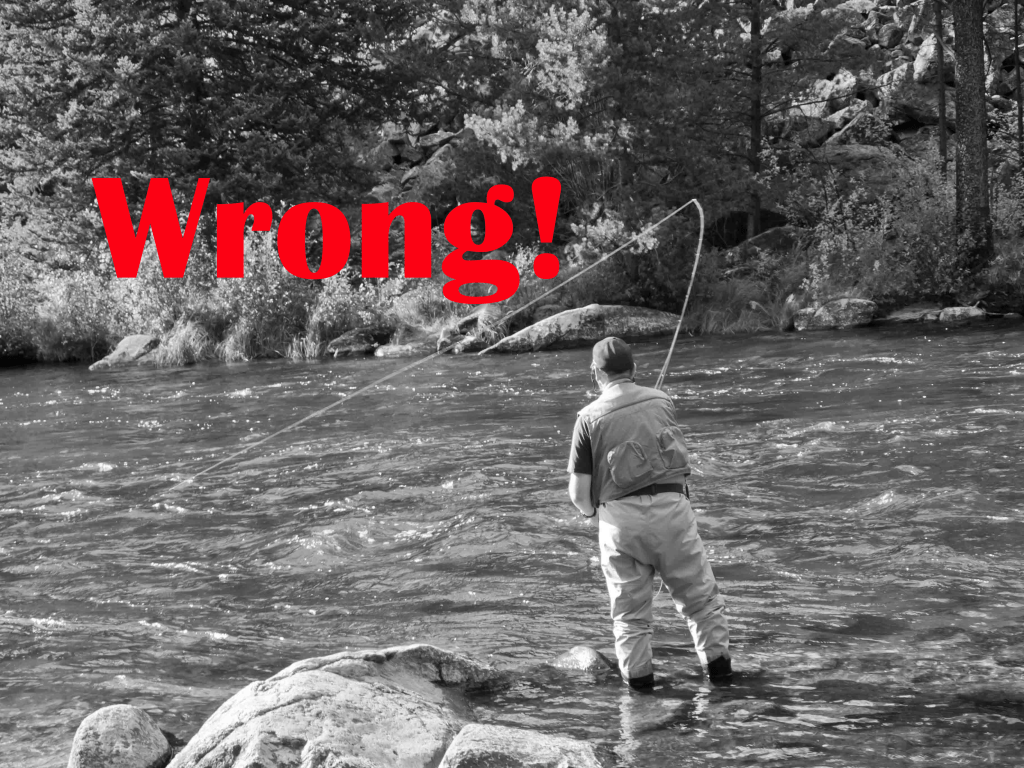 man fighting fish downstream fly fishing