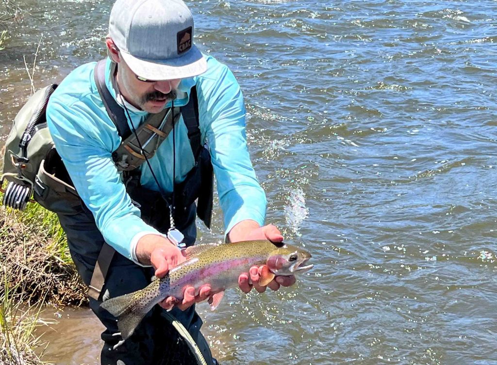 Dan Jones fishing guide holding rainbow trout gunnison river