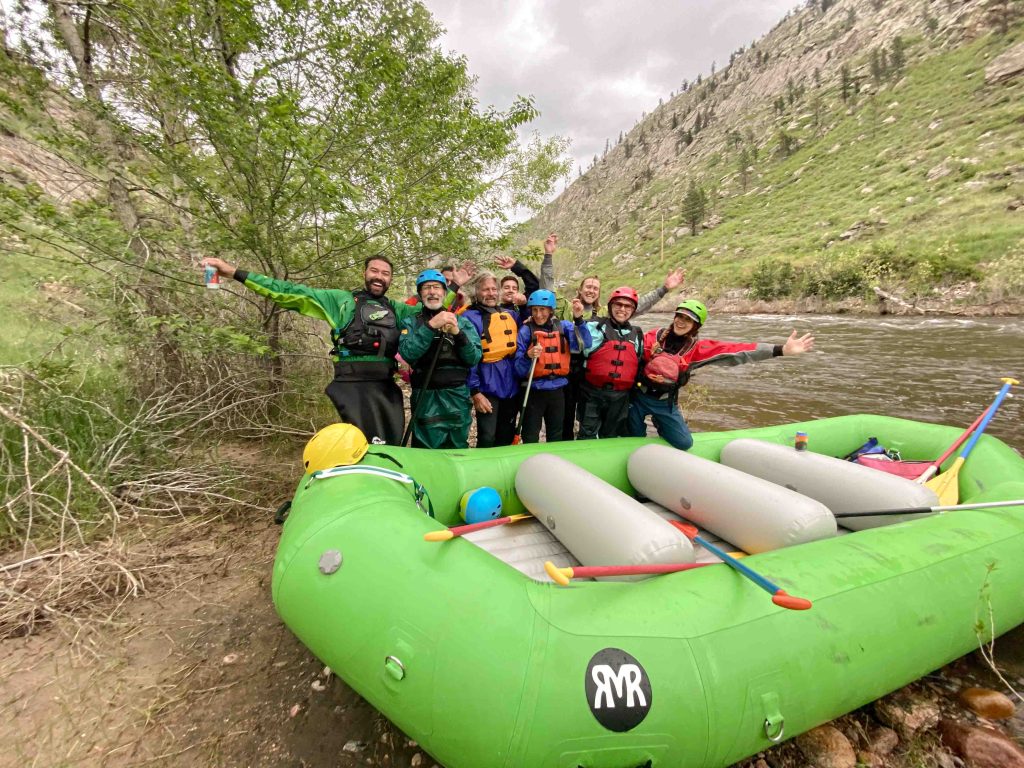 Family having fun rafting Poudre River Fort Collins green RMR Raft