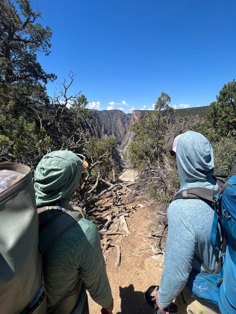 men backpacking view into black canyon gunnison national park