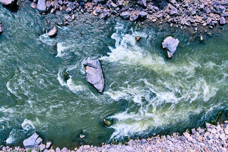 aerial image of river with boulders and rapids